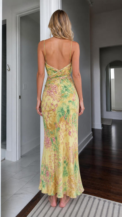 Back view showing open back detail of yellow floral maxi dress