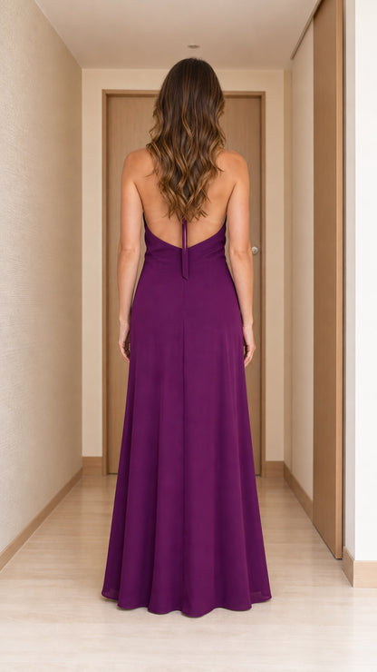 Back view of woman in purple halter neck maxi dress