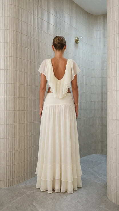 Back view of ivory two-piece set with backless ruffle detail