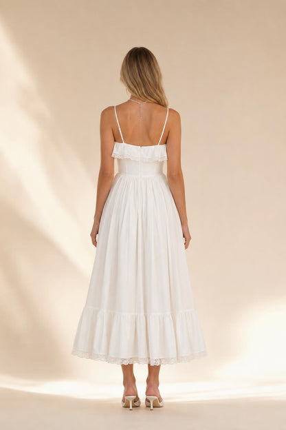 Back view of woman wearing white tiered midi dress