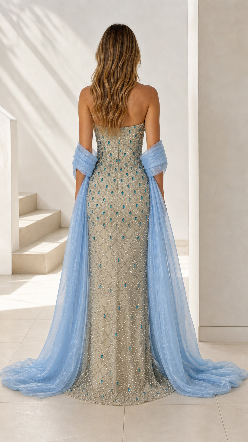 Back view of champagne beaded evening gown showing flowing stole train