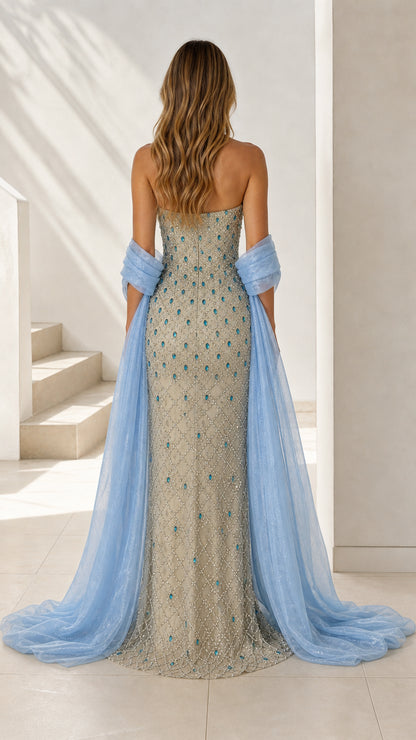 Back view of champagne beaded evening gown showing flowing stole train