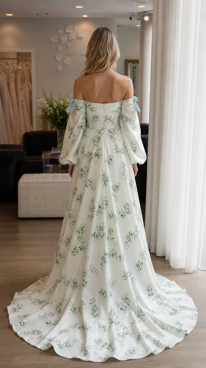 Back view of woman showing sweep train on white floral dress
