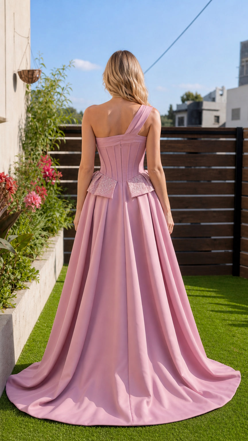 Back view showing sweeping train on pink formal gown