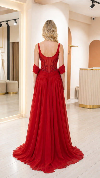 Back view of woman in red formal gown showing back neckline and draping