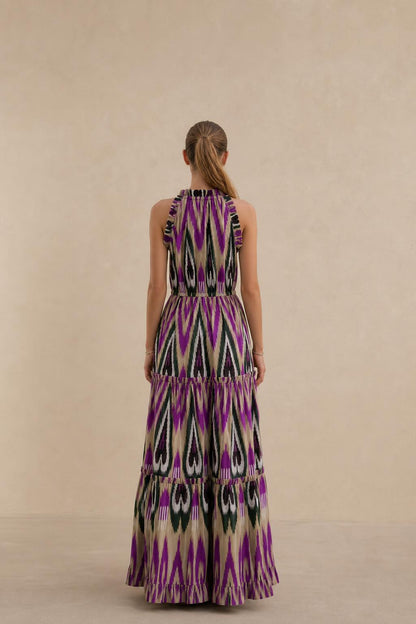 Back view of model in purple multi ikat print maxi dress