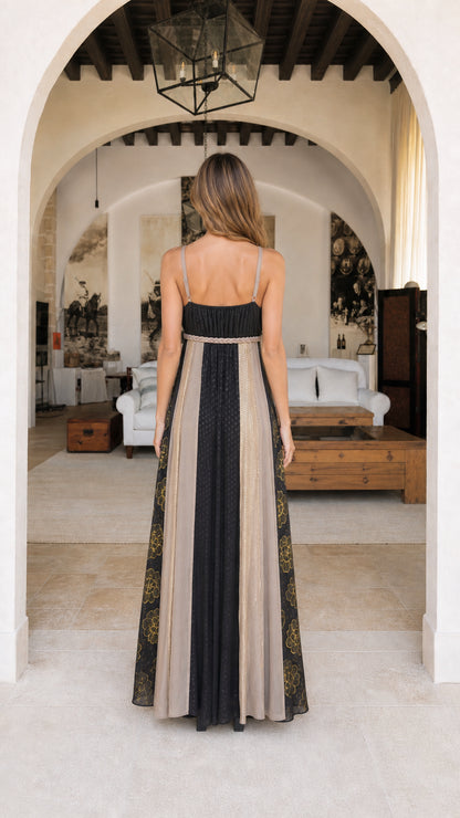 Back view of model showing strapped back detail on black maxi dress