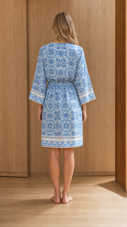 Back view of woman wearing blue printed resort dress