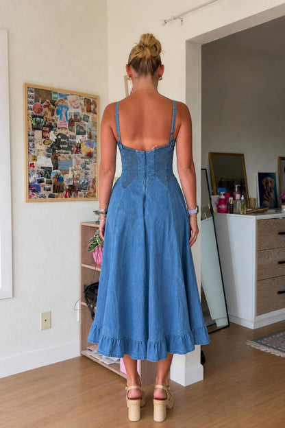 Back view of woman wearing blue denim midi dress