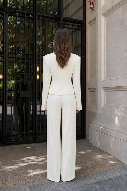 Model wearing white pinstripe suit, back view