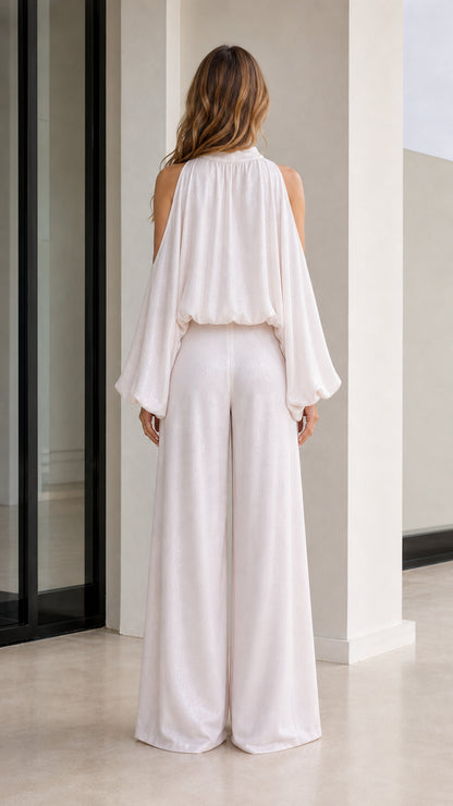 Back view showcasing the flowing cape-like drape of the white blouse