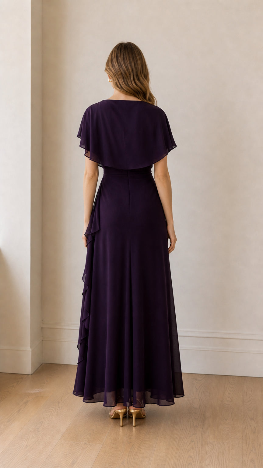 Back view of model showcasing the capelet overlay on the purple dress