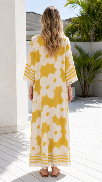 Back view of woman in yellow floral maxi dress