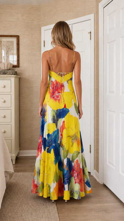 Back view of model wearing bright yellow floral maxi dress