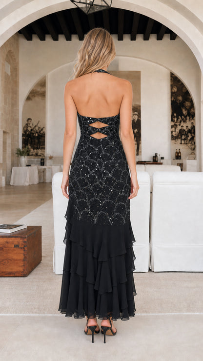 Back view of black dress showing open back design