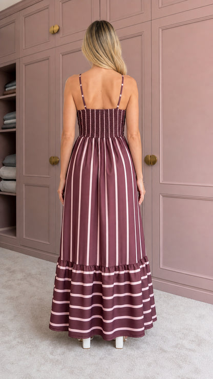 Woman wearing burgundy striped maxi dress back view showing smocked detail