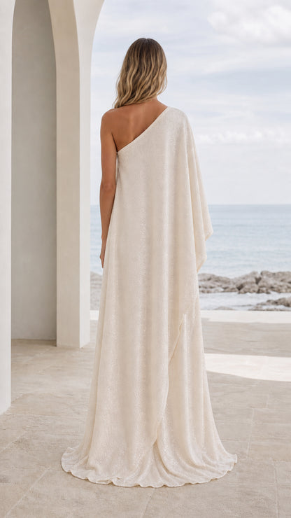 Back view of woman in champagne one-shoulder maxi dress