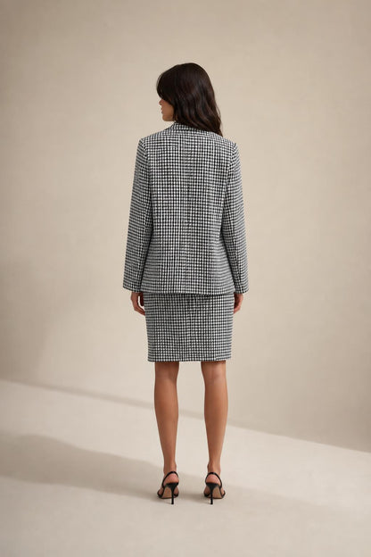 Back view of model wearing houndstooth blazer and skirt set