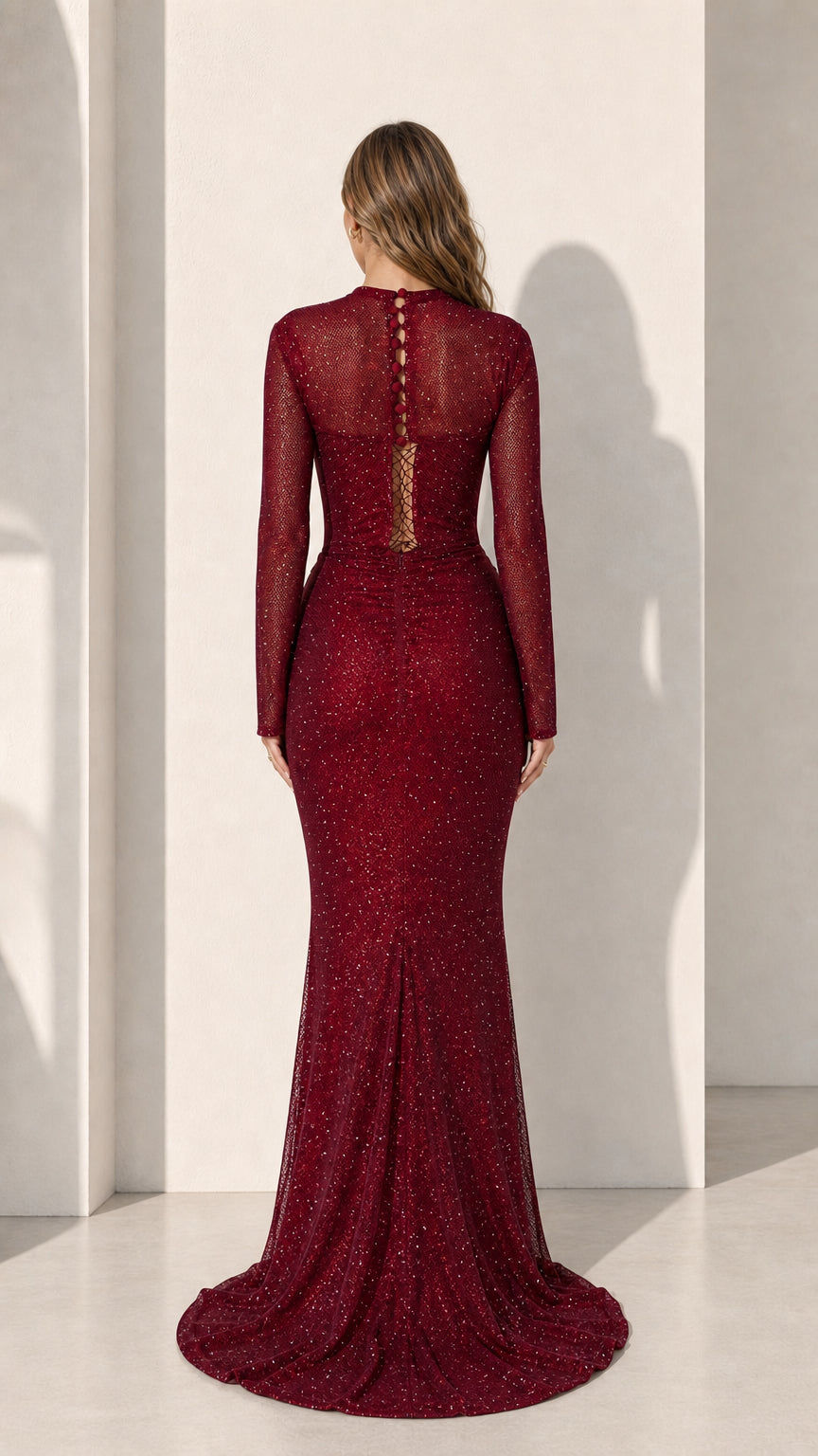 Model wearing burgundy long sleeve glitter evening gown, back view with button details