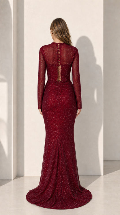 Model wearing burgundy long sleeve glitter evening gown, back view with button details