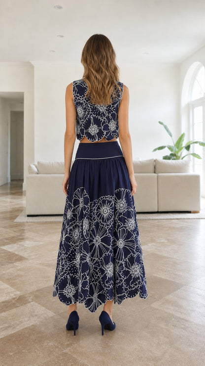 Back view of model wearing navy floral embroidered maxi skirt set