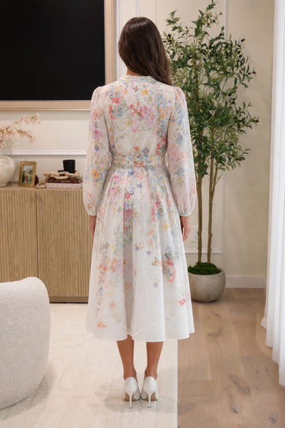 Back view of woman in white floral midi dress