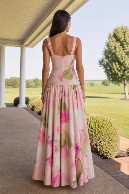 Back view of model showcasing back zipper and drape of pink floral maxi dress