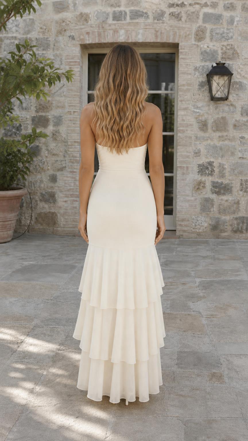 Back view of cream halter maxi dress showing cascading ruffles