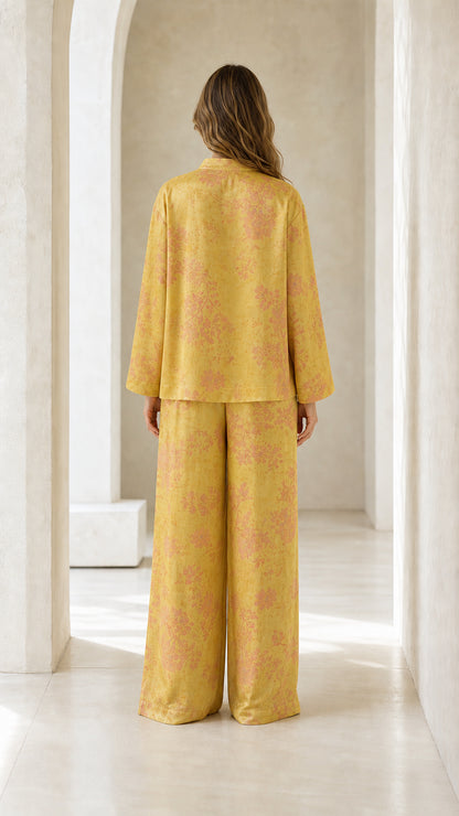 Back view of woman wearing yellow floral pants set