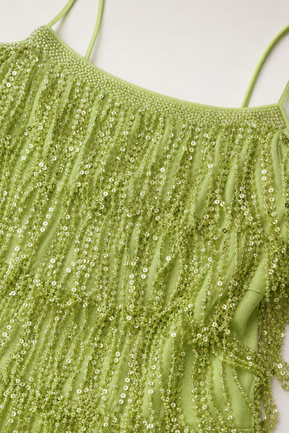Close-up detail of green sequin and bead fringe texture