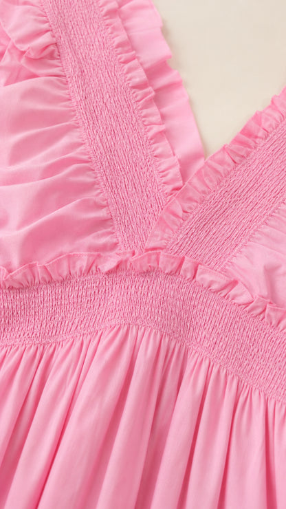 Close-up detail of smocked bodice and ruffled straps in pink