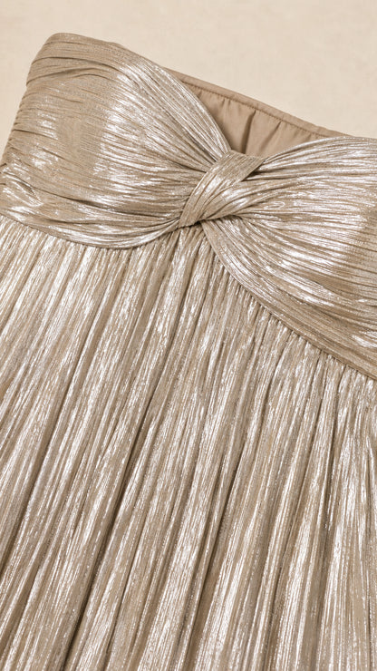 Close-up of knotted sweetheart bodice detail on gold metallic dress