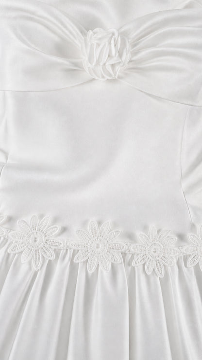 Close-up of floral bodice detail and embroidered skirt seam on white set