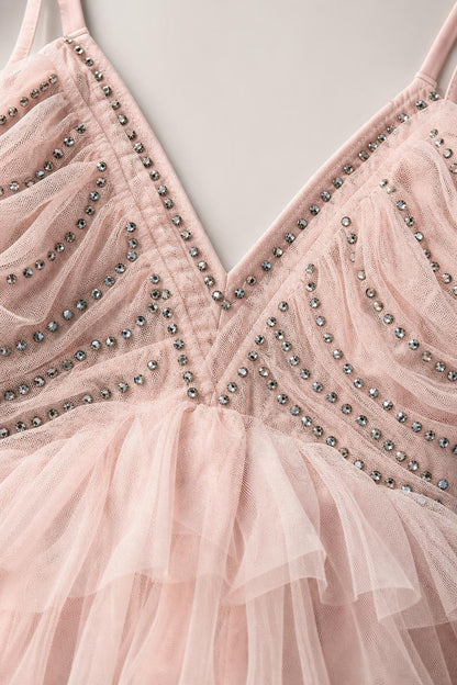 Close-up of V-neckline and bead embellishments on pink tulle dress