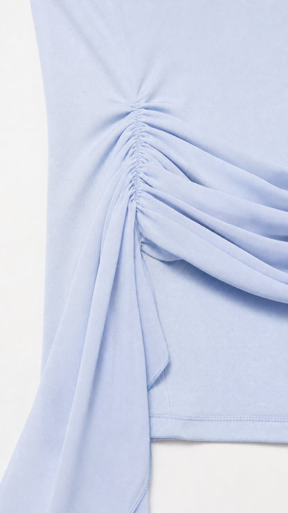 Close-up detail of hip ruching and fabric sash