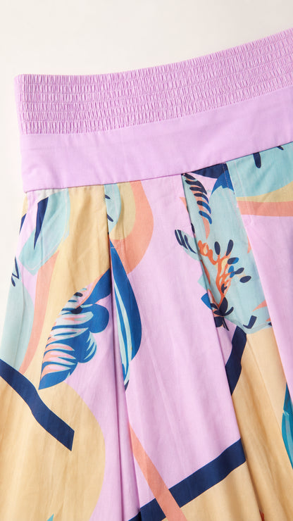 Close-up detail of the pink dress smocked bandeau and abstract pattern