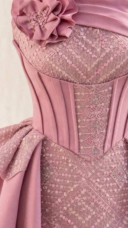 Close-up detail of structured corset bodice and floral shoulder accent