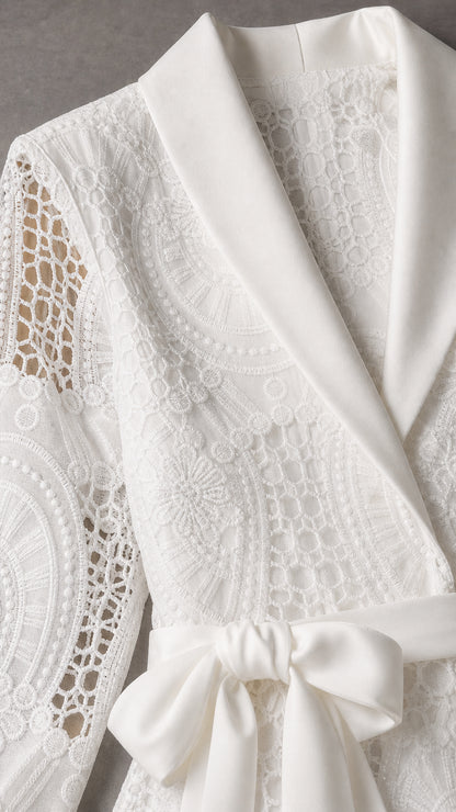 Close-up detail of white satin shawl collar and lace texture