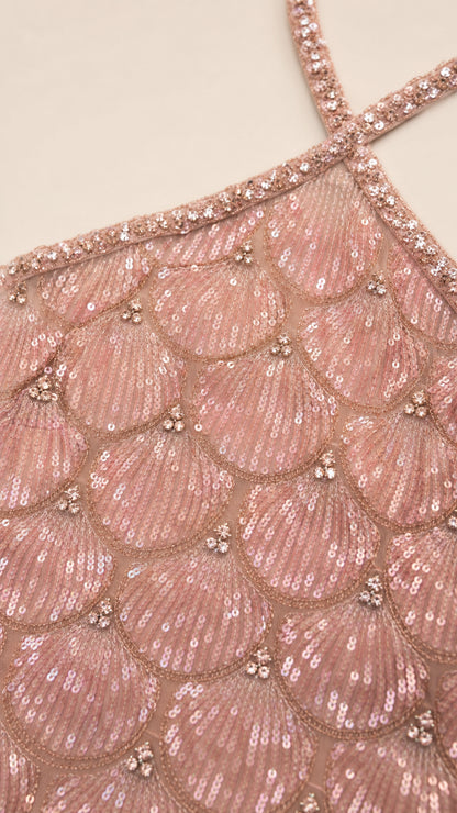 Close-up detail of scalloped sequin pattern and beaded halter strap