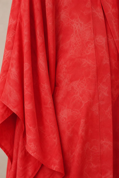 Close-up detail of red woven fabric with subtle tonal pattern