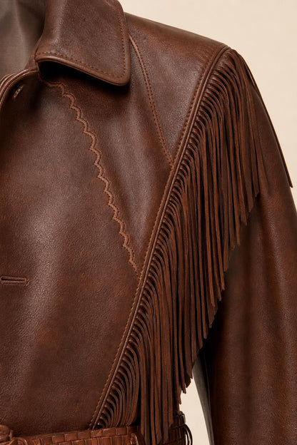 Close-up detail of the brown jacket's lapel, stitching, and fringe trim