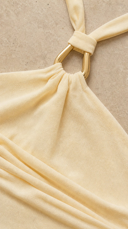 Close up of metal ring halter neck detail on yellow dress