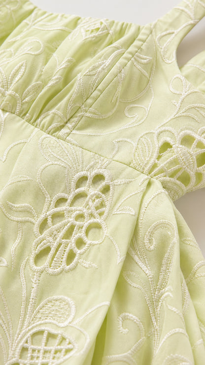 Close-up detail of tonal floral embroidery and eyelet cutwork on Light Green fabric