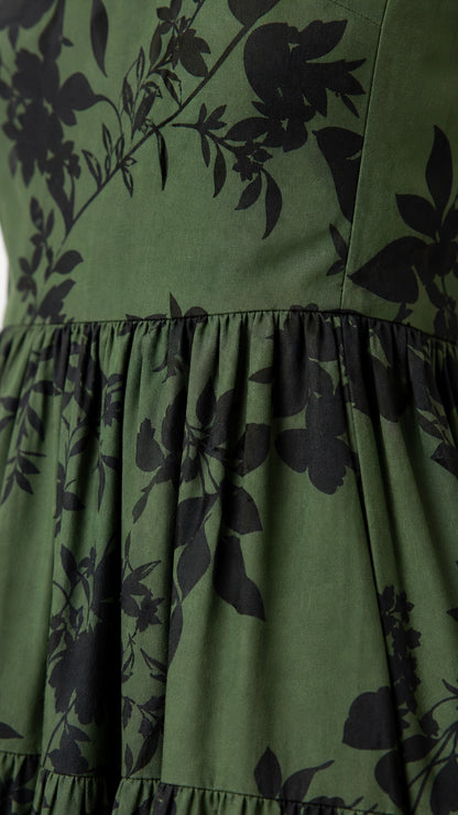Close up of green floral fabric and tiered skirt detail