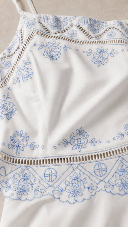 Close-up of floral embroidery and cutout trim details