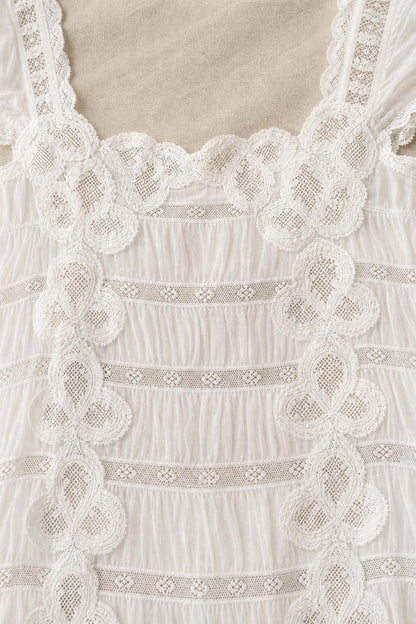 Close-up detail of crochet lace trim and square neckline