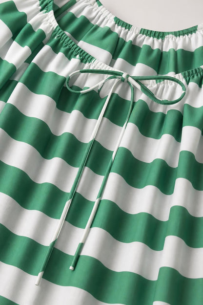 Close up of green and white striped fabric and drawstring neckline
