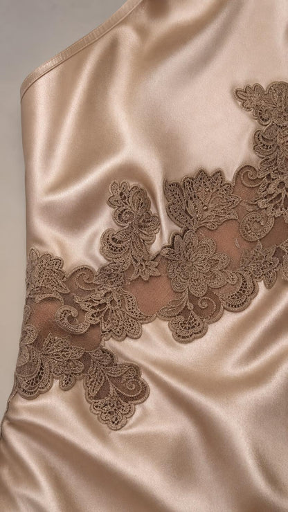 Close-up detail of lace applique and satin texture on dress
