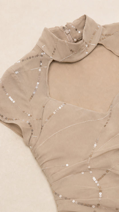 Close-up detail of neckline, choker, and sequin pattern