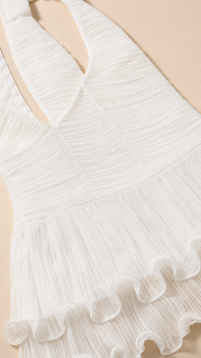 Close-up detail of white textured fabric and ruffle hem
